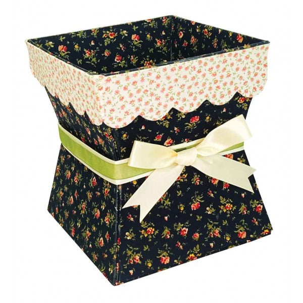A decorative gift box with a dark navy floral print, a cream scalloped inner liner, a light green ribbon band, and a cream satin bow, shown on a plain white background.