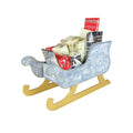 Decorative sleigh with Christmas-themed items on a white background.