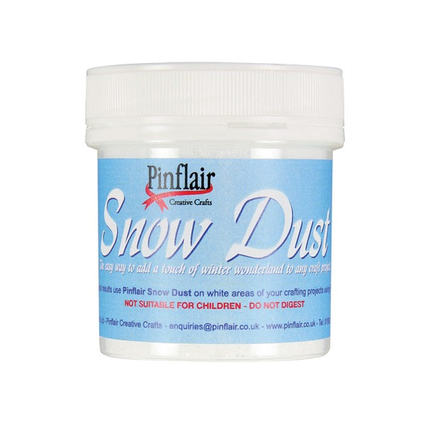 A white plastic jar of Pinflair Creative Crafts Snow Dust craft powder, featuring a light blue label with white and red text, on a solid white background.